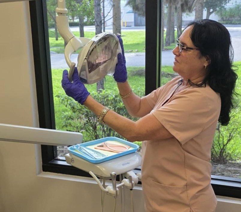 Dental assistant preparing a treatment room at our Bonita Springs office
