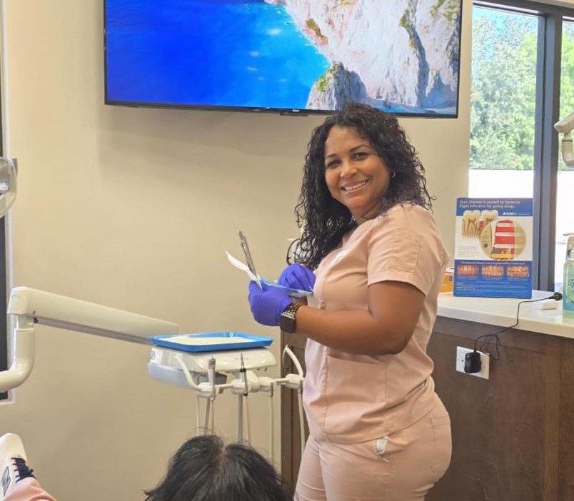 Dental assistant with a patient in a treatment room at our Bonita Springs office