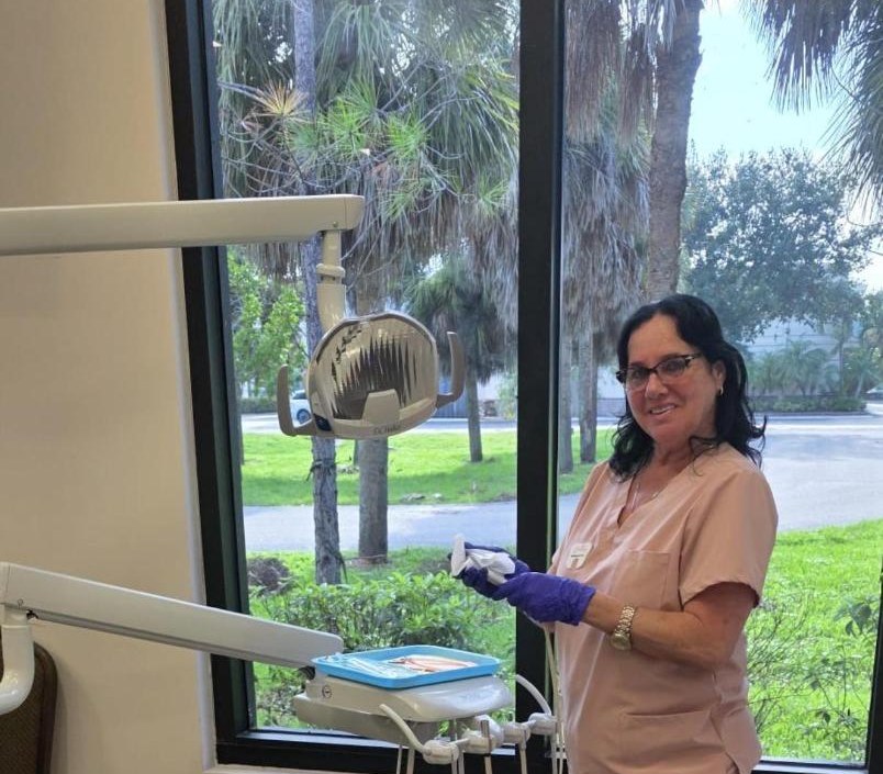 Dental assistant in a treatment room overlooking the palms at our Bonita Springs office