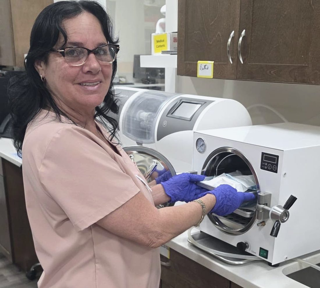 Team member sterilizing instruments in our autoclave